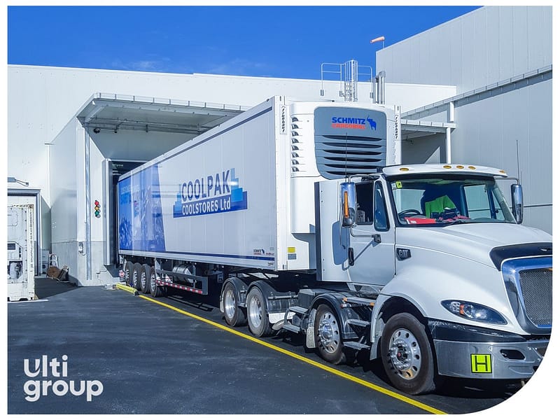 A Coolpak refrigerated truck backed into a loading dock bay.